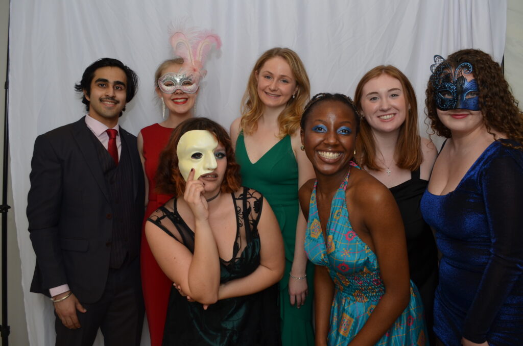 Trinity students having fun in the photo booth at “Trinsquerade” Saints’ Ball, 2022