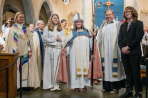 Bishop surrounded by other religious figures and family members